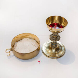 Why does the Church use gold chalices?