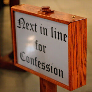 Why do Catholics confess their sins to a priest?